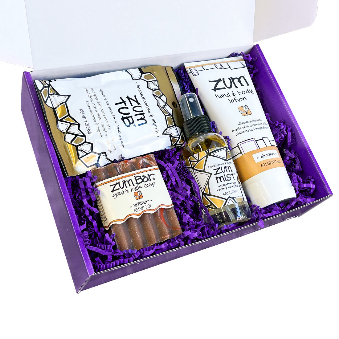 Purple gift box open with purple crinkle and Zum products inside.